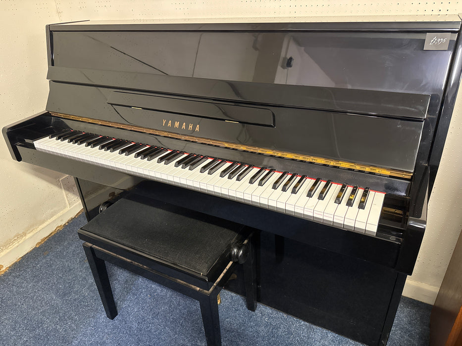 Yamaha C110A compact upright piano in polished ebony, keyboard open, at The Piano Gallery showroom